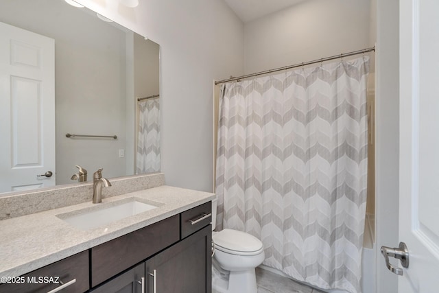 bathroom with vanity, a shower with shower curtain, and toilet