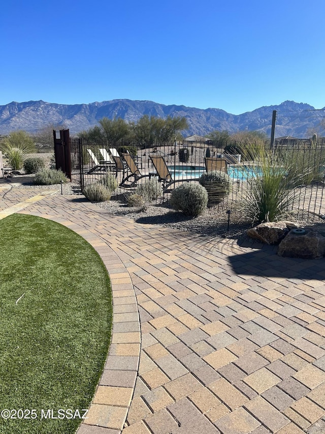 view of community with a mountain view and a patio