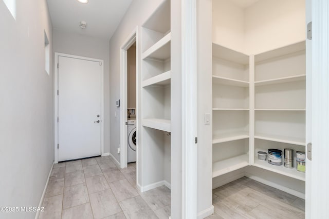 interior space with light wood-type flooring and washer / clothes dryer