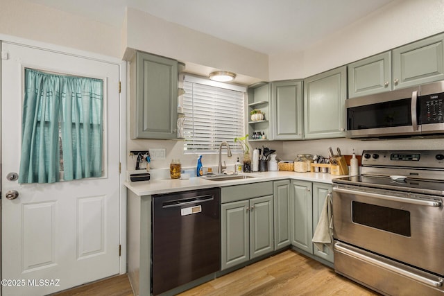 kitchen featuring stainless steel appliances, light hardwood / wood-style floors, and sink