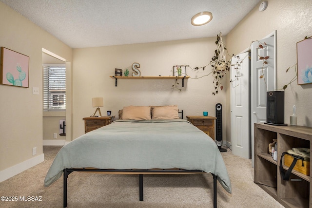 carpeted bedroom featuring a textured ceiling