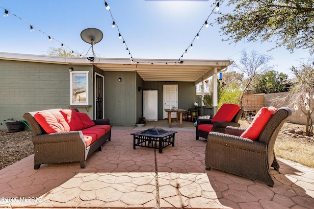 view of patio featuring an outdoor living space with a fire pit