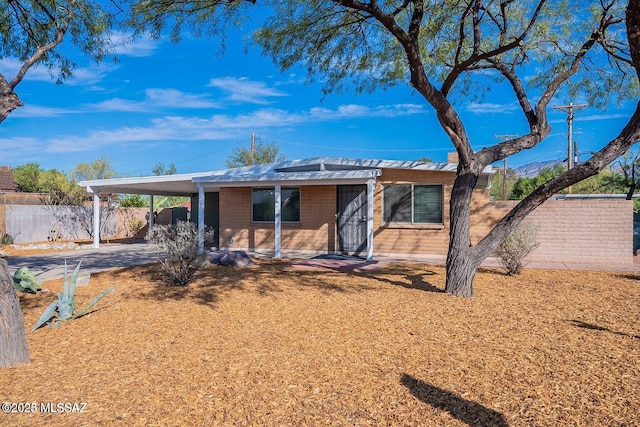 ranch-style home featuring a carport