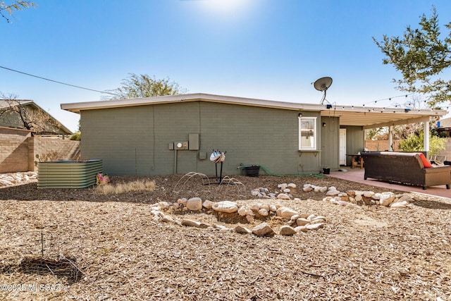 rear view of house featuring a patio and outdoor lounge area