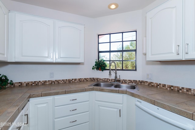 kitchen featuring white cabinets, white dishwasher, and sink