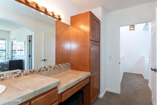 bathroom featuring decorative backsplash and vanity