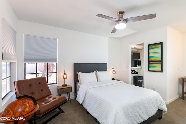 bedroom with dark carpet and ceiling fan