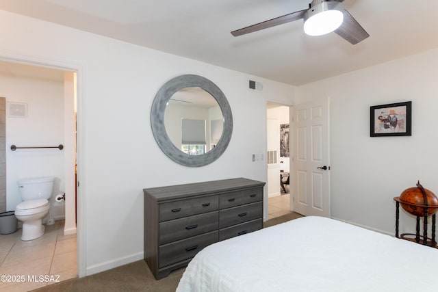 bedroom with light tile patterned floors, ensuite bath, and ceiling fan