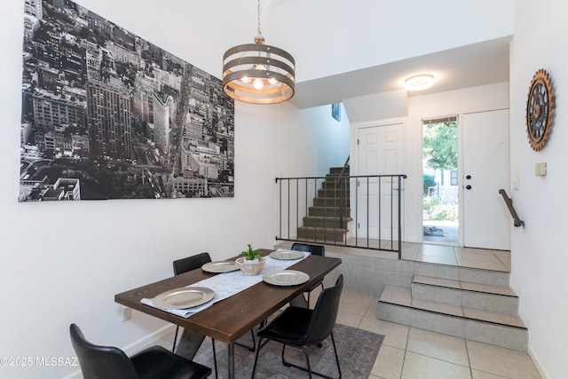 dining space with light tile patterned floors and a notable chandelier