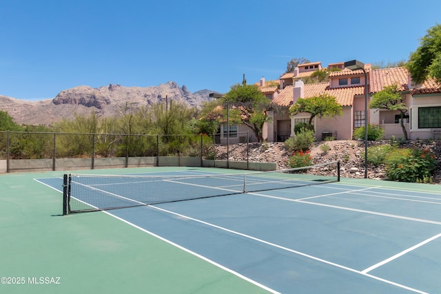 view of sport court with basketball hoop and a mountain view