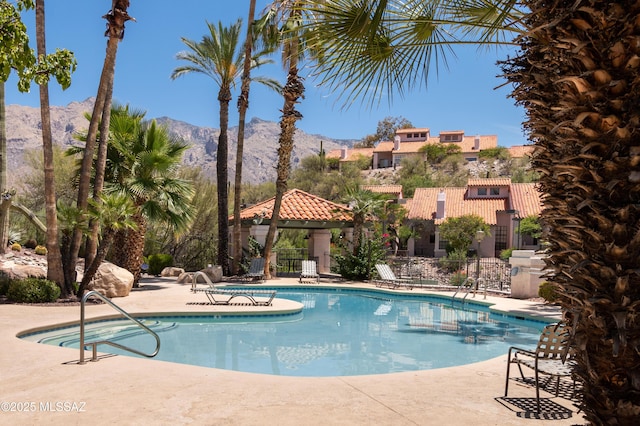 view of swimming pool featuring a mountain view, a gazebo, and a patio