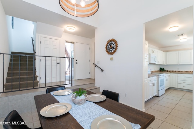 dining space featuring light tile patterned floors