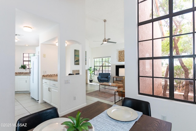 dining space with ceiling fan and light tile patterned floors