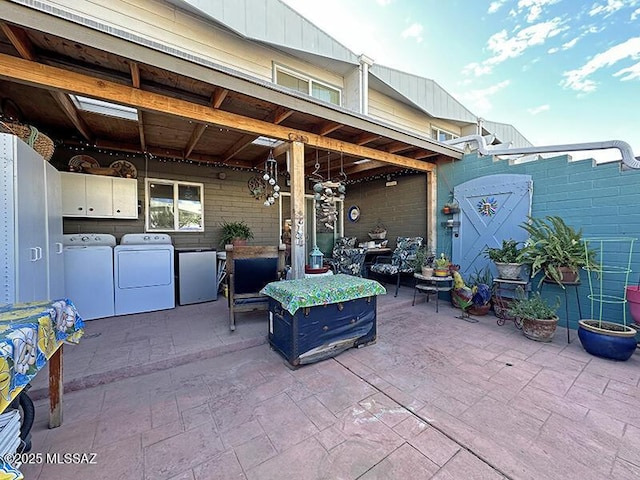 view of patio with washer and clothes dryer and an outdoor kitchen