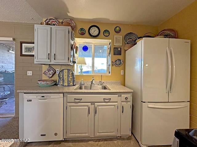 kitchen with sink, white cabinets, and white appliances