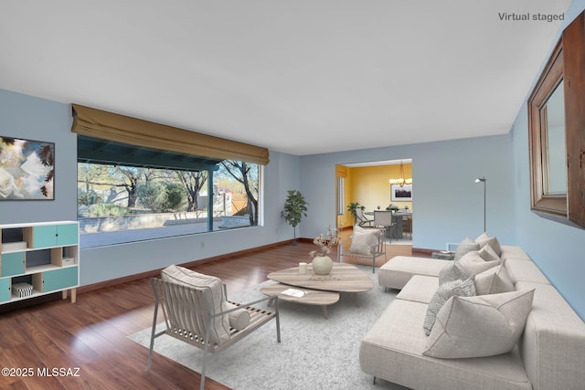 living room with wood-type flooring and a notable chandelier