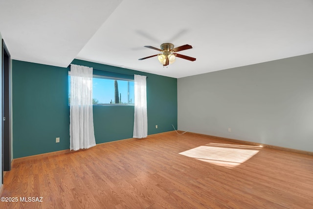 unfurnished room featuring ceiling fan and light wood-type flooring