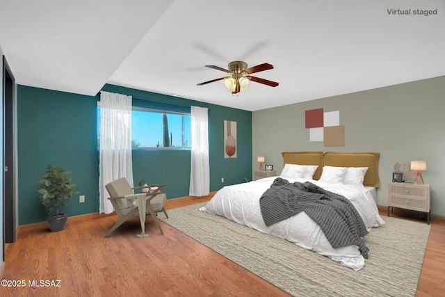 bedroom with ceiling fan and hardwood / wood-style flooring