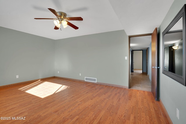 unfurnished room with ceiling fan and light hardwood / wood-style flooring