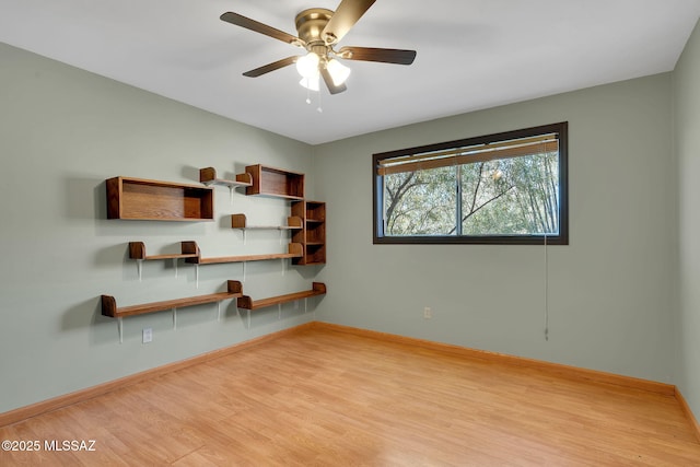 empty room with ceiling fan and light hardwood / wood-style floors