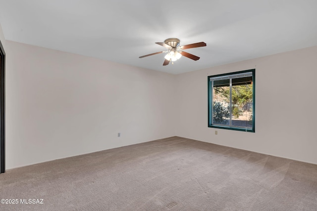 unfurnished room with ceiling fan and carpet flooring