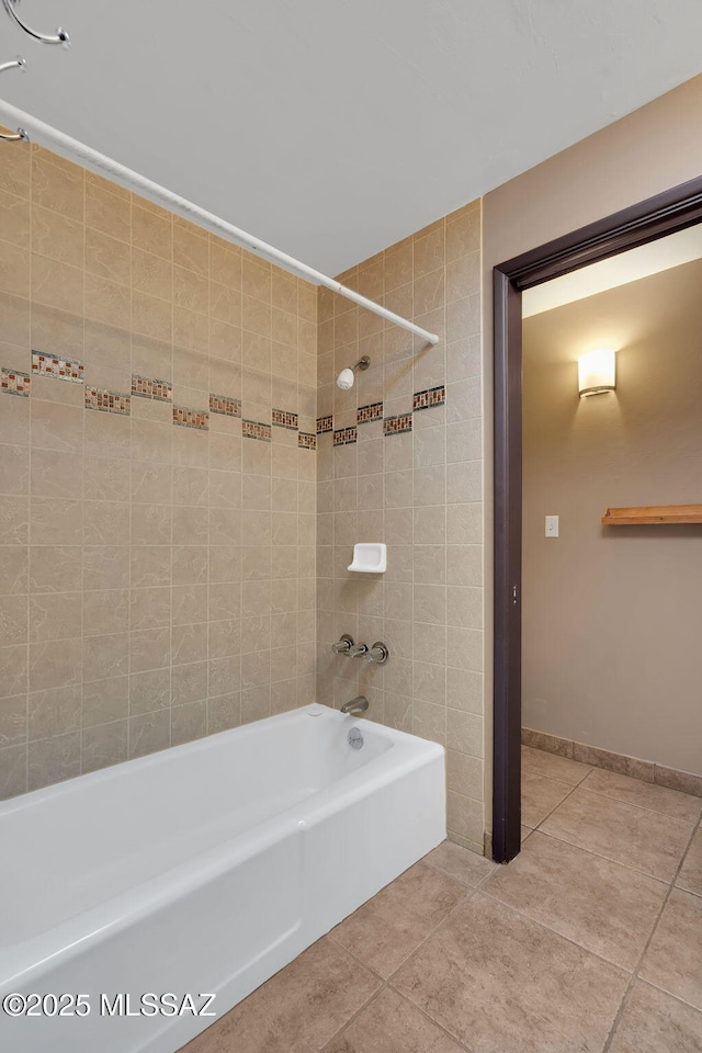 bathroom with tiled shower / bath combo and tile patterned flooring