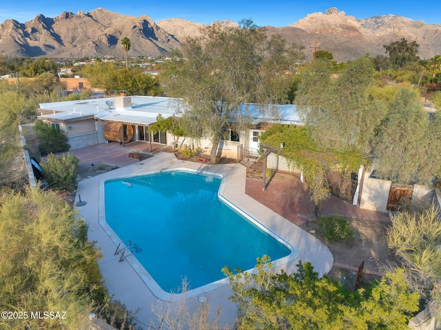 view of swimming pool featuring a mountain view and a patio