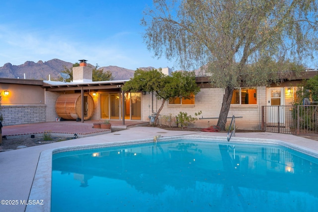 view of swimming pool featuring a mountain view and a patio