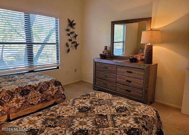 bedroom featuring light colored carpet