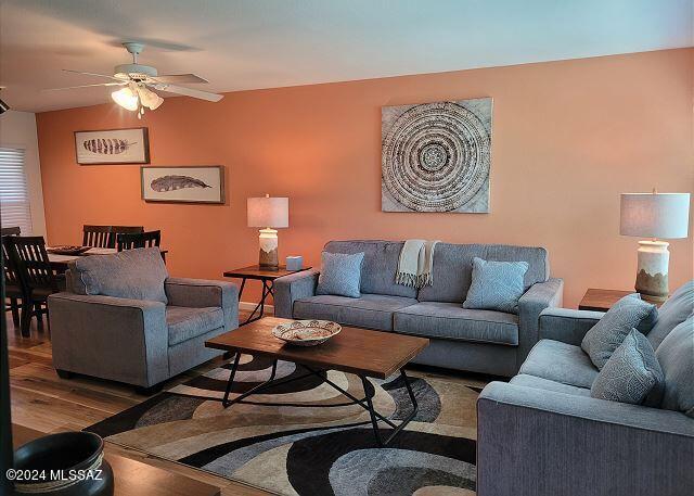 living room with ceiling fan and hardwood / wood-style flooring