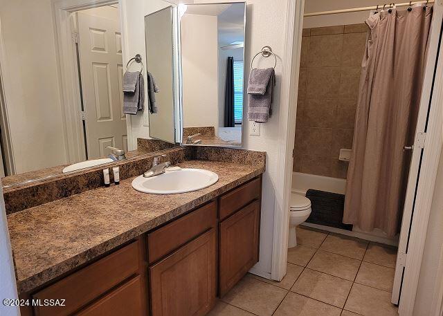 full bathroom featuring tile patterned floors, vanity, shower / tub combo, and toilet