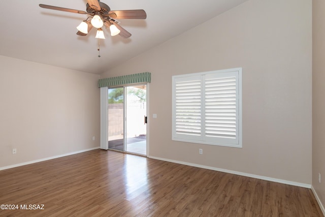 empty room with hardwood / wood-style flooring, vaulted ceiling, and ceiling fan