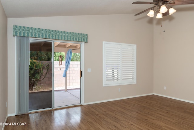 empty room featuring ceiling fan, hardwood / wood-style floors, and vaulted ceiling