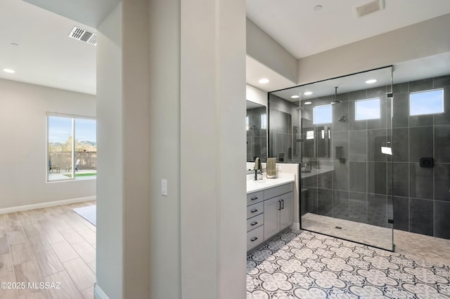 bathroom featuring vanity and a tile shower