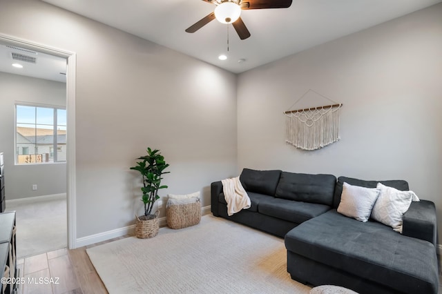 living room with light wood-type flooring and ceiling fan