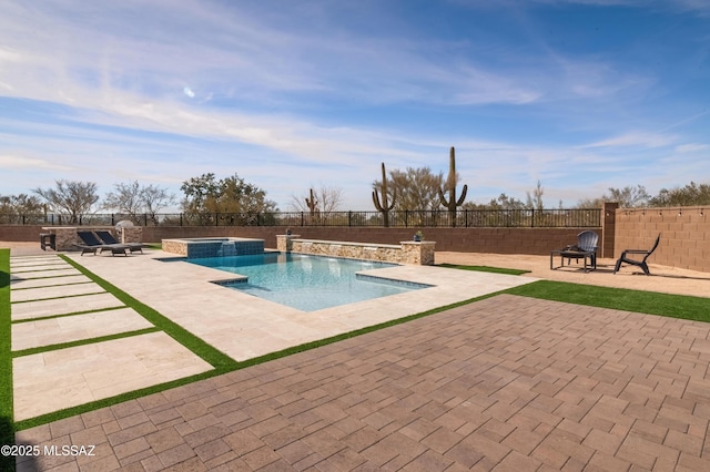 view of pool with an in ground hot tub, pool water feature, a patio area, and an outdoor fire pit