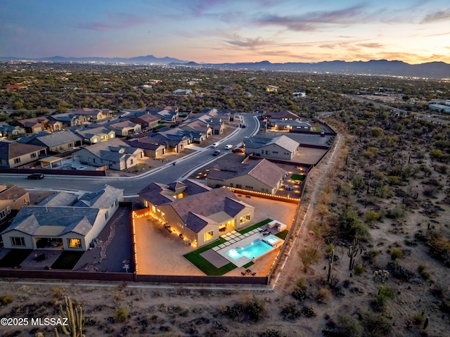 aerial view at dusk featuring a mountain view