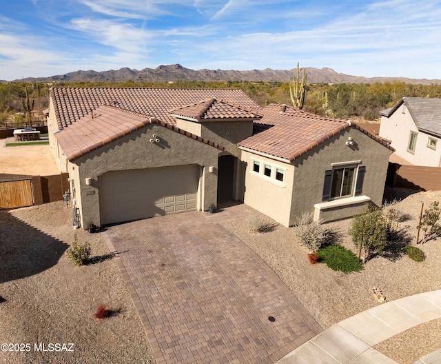 mediterranean / spanish-style house featuring a mountain view and a garage