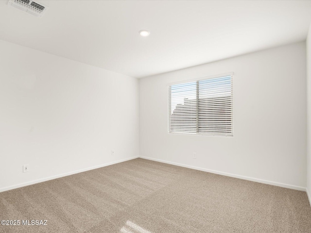 unfurnished room with carpet floors, recessed lighting, visible vents, and baseboards