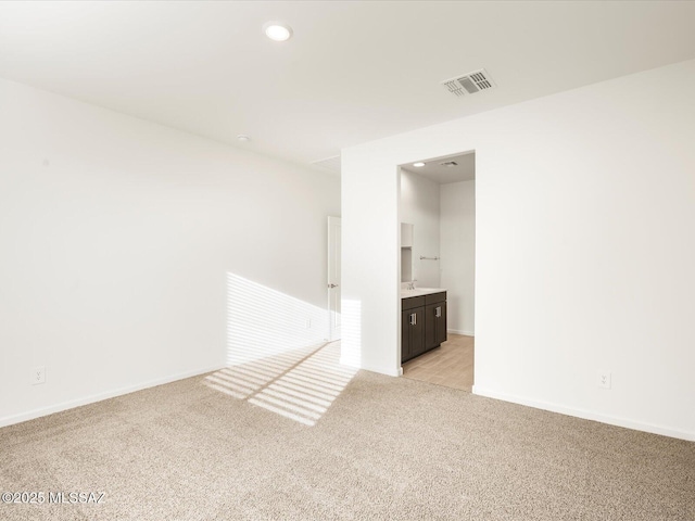 spare room featuring recessed lighting, baseboards, visible vents, and light colored carpet