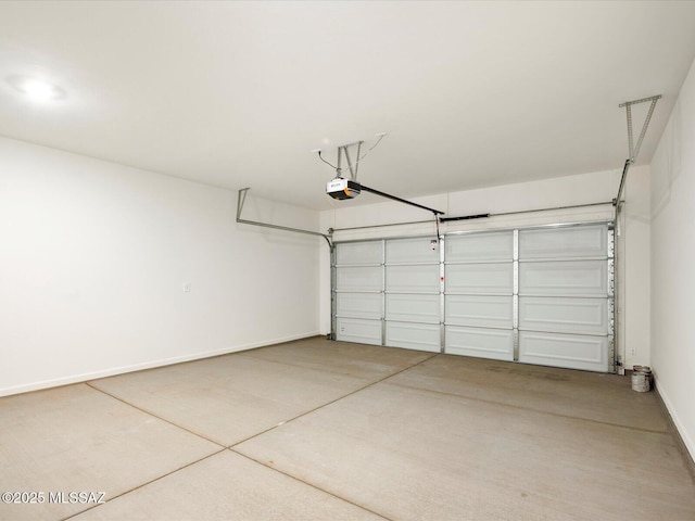 garage with baseboards and a garage door opener