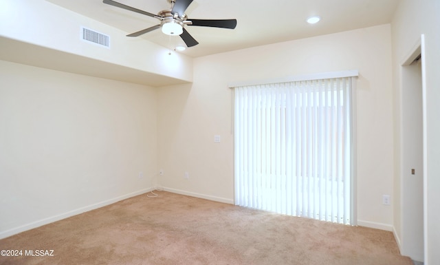 unfurnished room featuring ceiling fan and light colored carpet