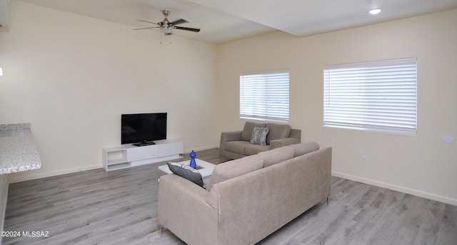 living room with ceiling fan and light hardwood / wood-style flooring