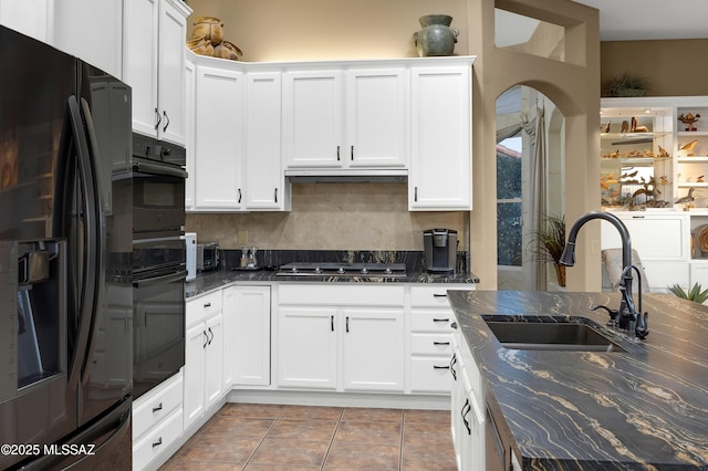 63111 E Mountain Crest Dr, Tucson, AZ 85739 - kitchen featuring black refrigerator with ice dispenser, a sink, stainless steel gas stovetop, white cabinetry, and dark stone counters