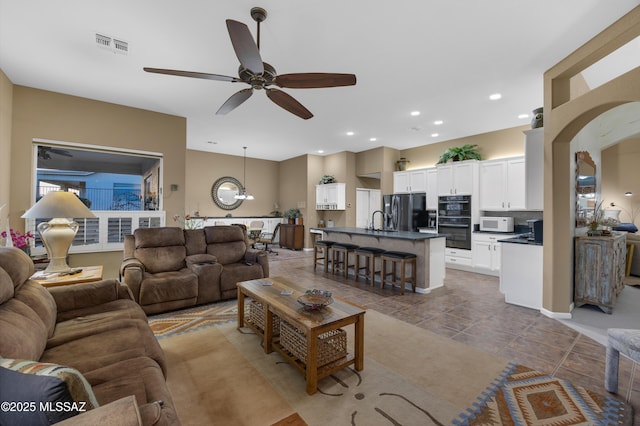 63111 E Mountain Crest Dr, Tucson, AZ 85739 - living area featuring ceiling fan, light tile patterned flooring, recessed lighting, and a chandelier