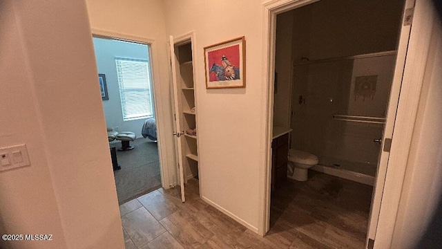 bathroom with toilet and wood-type flooring