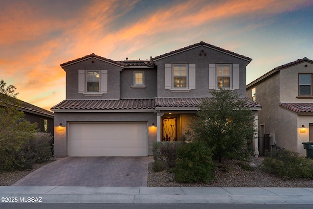 mediterranean / spanish house with a garage