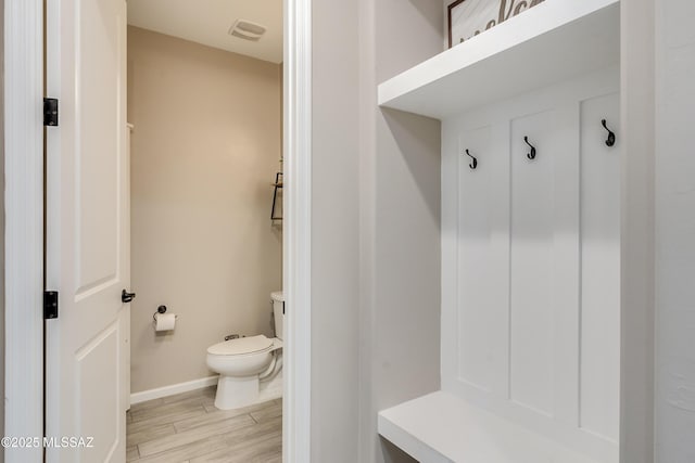 mudroom with light hardwood / wood-style floors