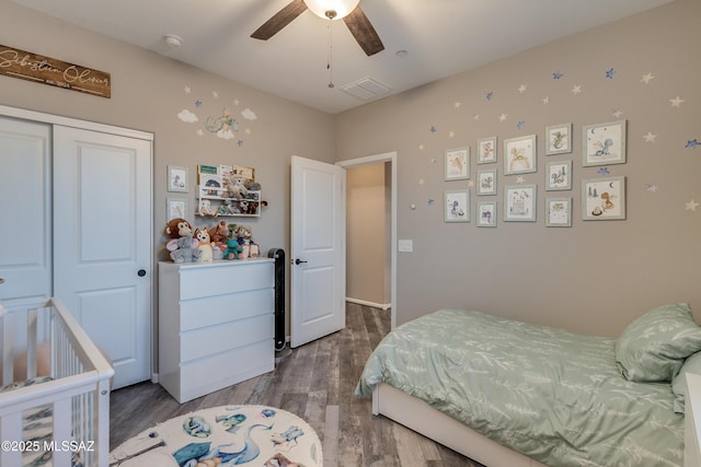 bedroom featuring ceiling fan, hardwood / wood-style floors, and a closet