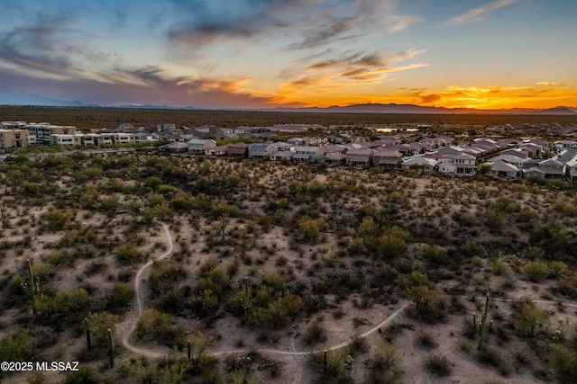 aerial view at dusk featuring a mountain view